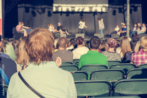 Rear view of audience at open air theatre in city center. photo