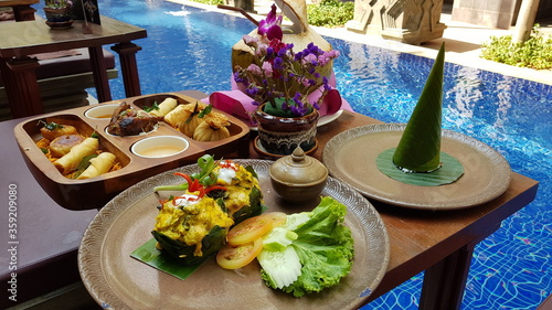 Famous traditional Cambodian Khmer delicacy, the Amok Fish. Vegetables and soya sauce.