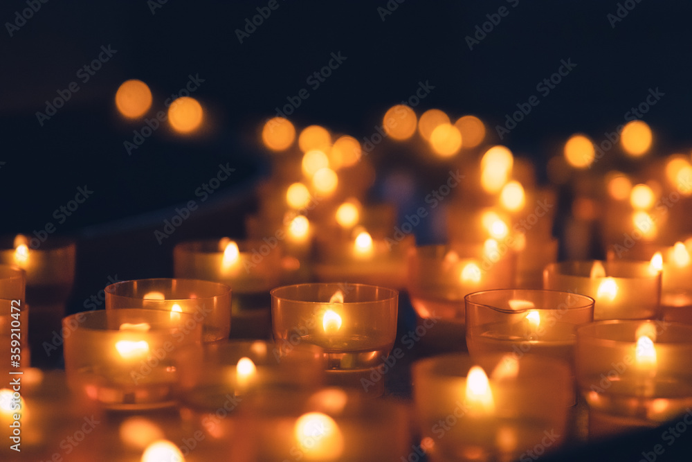 Lit prayer church candles with warm light Lit prayer church candles with warm light