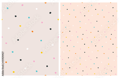 Cute Hand Drawn Abstract Irregular Polka Dots Vector Pattern Set. Colorful Tiny Brush Dots Isolated on a Salmon Pink Background. Simple Bright Dotted Vector Print. 
