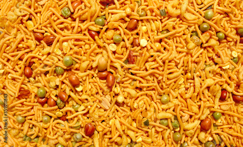 Принти на полотні Indian mix snack, deep fried salty dish - chivda made of flour, mixed with roasted nuts, pepper, pulses, spice and green peas