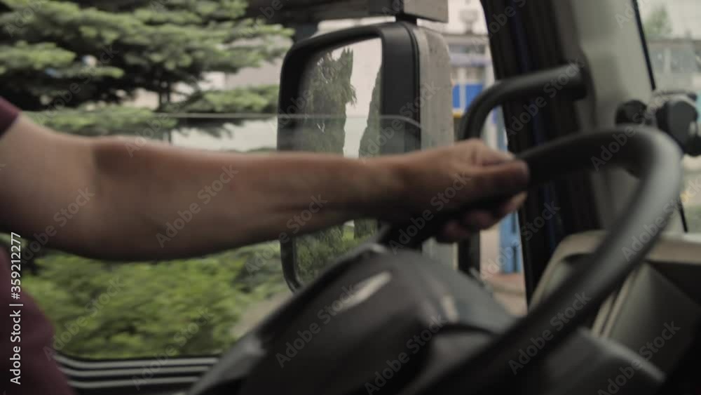 Truck driver rides to destination. View for window and mirror.Man driving car at country road on warm summer day. View from the lorry cab. Slow motion Close up Truck driver rides to destination. View for window and mirror.Man driving car at country road on warm summer day. View from the lorry cab. Slow motion Close up