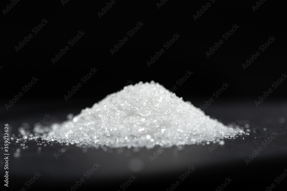 White sugar on a black background. selective focus
