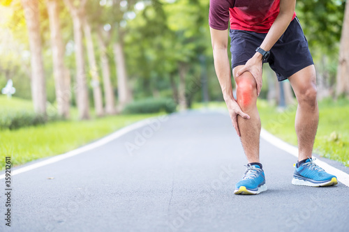 Young adult male with muscle pain during running. runner have knee ache due to Runners Knee or Patellofemoral Pain Syndrome, osteoarthritis and Patellar Tendinitis. Sports injuries and medical concept