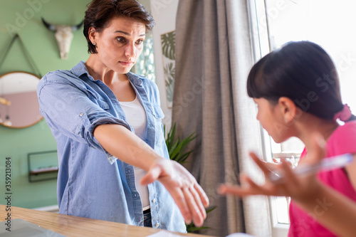 a mother getting upset to explain a school lesson to her daughter and who are at home