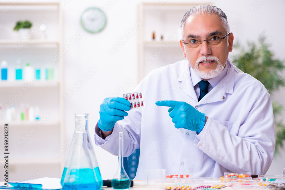 Old male chemist working in the lab Old male chemist working in the lab