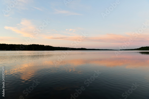 reflection of pink clouds in a river at sunrise