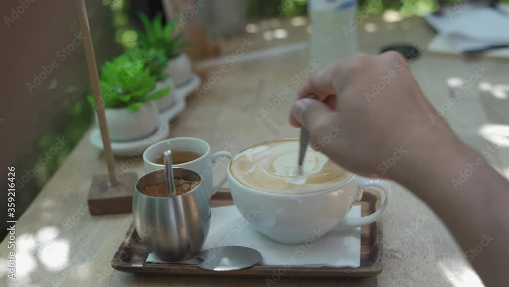 Man's hand is brewing coffee in a coffee shop Man's hand is brewing coffee in a coffee shop