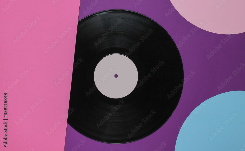 Fototapeta premium Retro vinyl record on colored background with blue pink circles. Retro minimalism. Top view