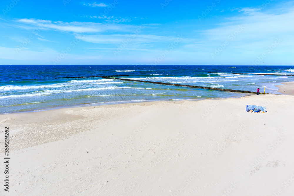 Obraz premium Beautiful white sand beach and blue sea near Kolobrzeg, Baltic Sea coast, Poland