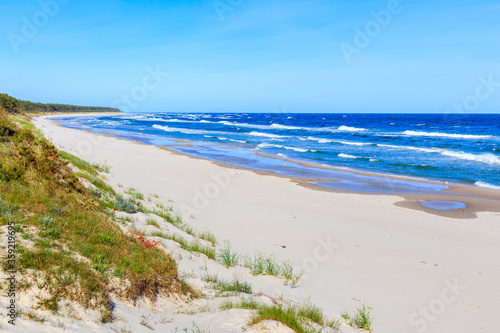 Fototapeta Naklejka Na Ścianę i Meble -  Beautiful white sand beach and blue sea near Kolobrzeg, Baltic Sea coast, Poland