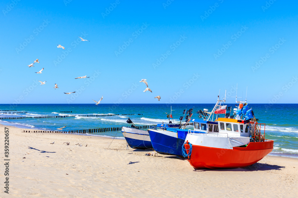 Fishing boats on sandy beach in Chlopy village port, Baltic Sea coast, Poland - obrazy, fototapety, plakaty 
