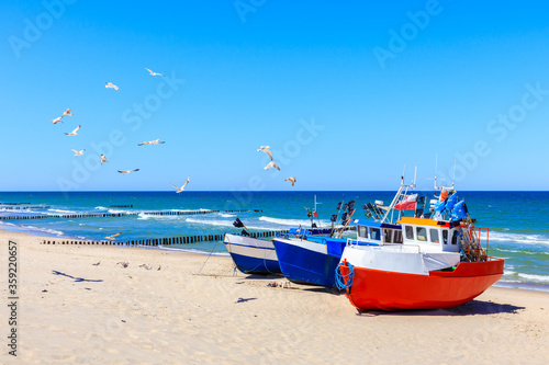 Fishing boats on sandy beach in Chlopy village port, Baltic Sea coast, Poland