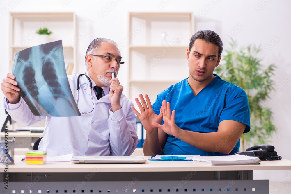 Two male doctors working in the clinic Two male doctors working in the clinic