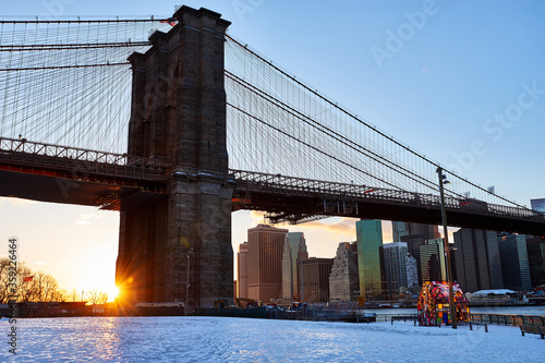 Fototapeta Naklejka Na Ścianę i Meble -  Bridge- Brooklyn- Sunset- Winter- Snow- New York City- Manhattan- United States- USA.