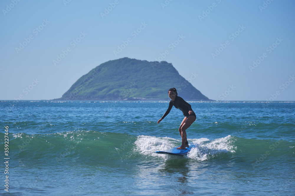 Asian girl doing surfing