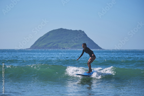Photography Asian girl doing surfing