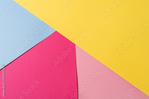 Pink,yellow and blue colored abstract paper , with geometric shape for using as background.