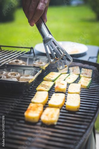 Fototapeta Naklejka Na Ścianę i Meble -  BBQ on weekend. Grill cheese and vegetables on gas grill. Outdoors.