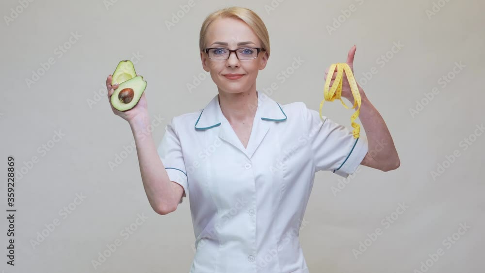nutritionist doctor healthy lifestyle concept - holding organic avocado nutritionist doctor healthy lifestyle concept - holding organic avocado