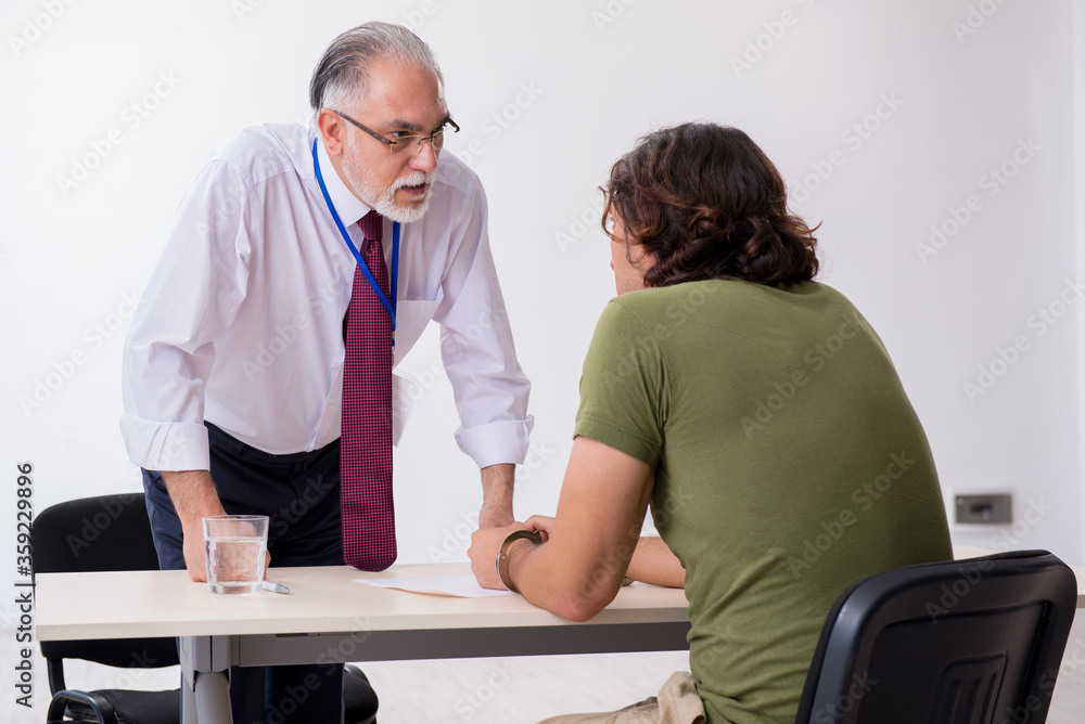 Young man meeting with advocate in pre-trial detention Young man meeting with advocate in pre-trial detention