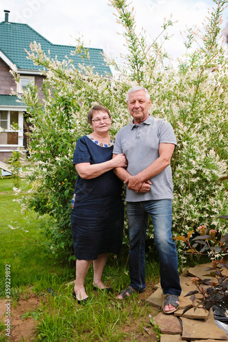 Beautiful senior couple - mature man and woman at their house, outdoors © natus111