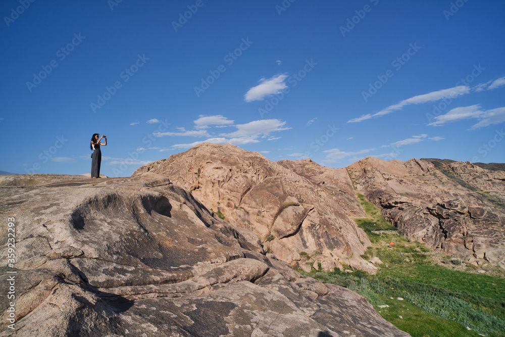 Asian girl taking picture of landscapes of rocks