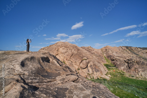 Asian girl taking picture of landscapes of rocks