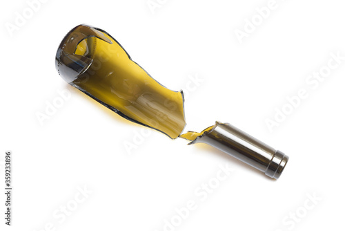 Shattered wine bottle. Parts of the broken bottle glass isolated on white background. Pieces of sharp broken glass. Concept of danger.