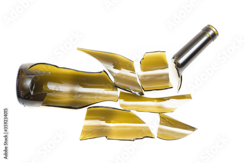 Shattered wine bottle. Parts of the broken bottle glass isolated on white background. Pieces of sharp broken glass. Concept of danger.