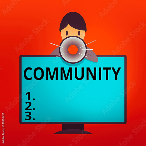 Writing note showing Community. Business concept for group of showing with a common characteristics living together Man Behind mounted PC Monitor Talking and Holding Megaphone photo