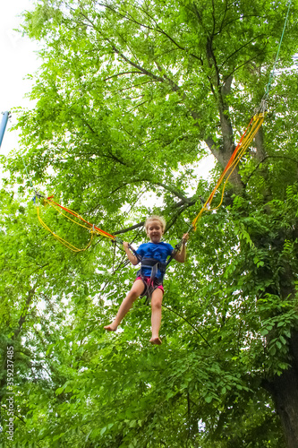 Girl bungee jumping in trampoline