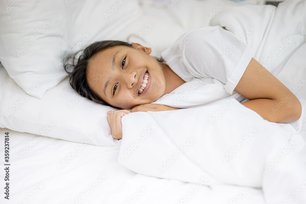 Teenage girl sleeping resting.Happy a good night. Girl sleep on a bed in a white room in the morning. Depression concept.Copy space background. Teenage girl sleeping resting.Happy a good night. Girl sleep on a bed in a white room in the morning. Depression concept.Copy space background.