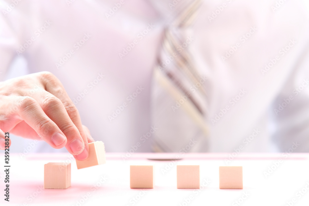 Businessman hand arranging wood cube stacking as step stair. Business concept growth success process and business word on table background and teamwork concept Businessman hand arranging wood cube stacking as step stair. Business concept growth success process and business word on table background and teamwork concept