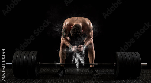 Muscular man workout with barbell at gym. Sports banner