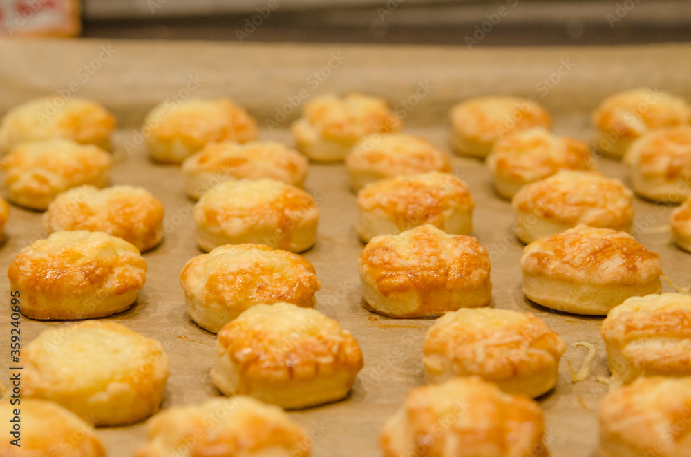 baked cheese scones on a baking sheet baked cheese scones on a baking sheet