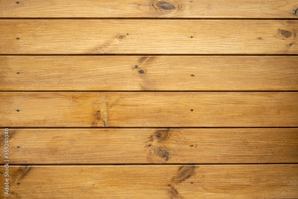 Fototapeta premium Wooden boards as a background. The wall of a wooden house
