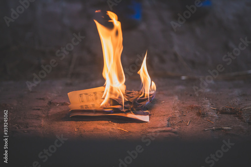 Preteen child, burning paper in the attic photo