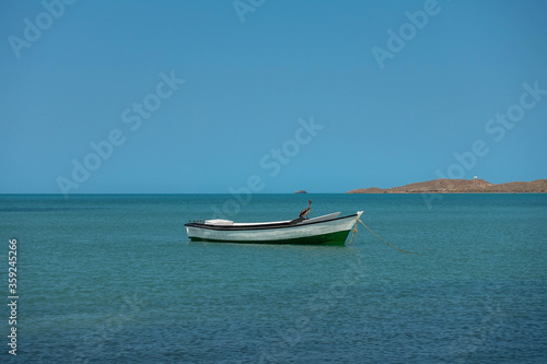 Lonely traditional Colombian fishing boat on sea water with clear water and blue sky - at Cabo de la vela, La guajira, Colombia © shinyoung