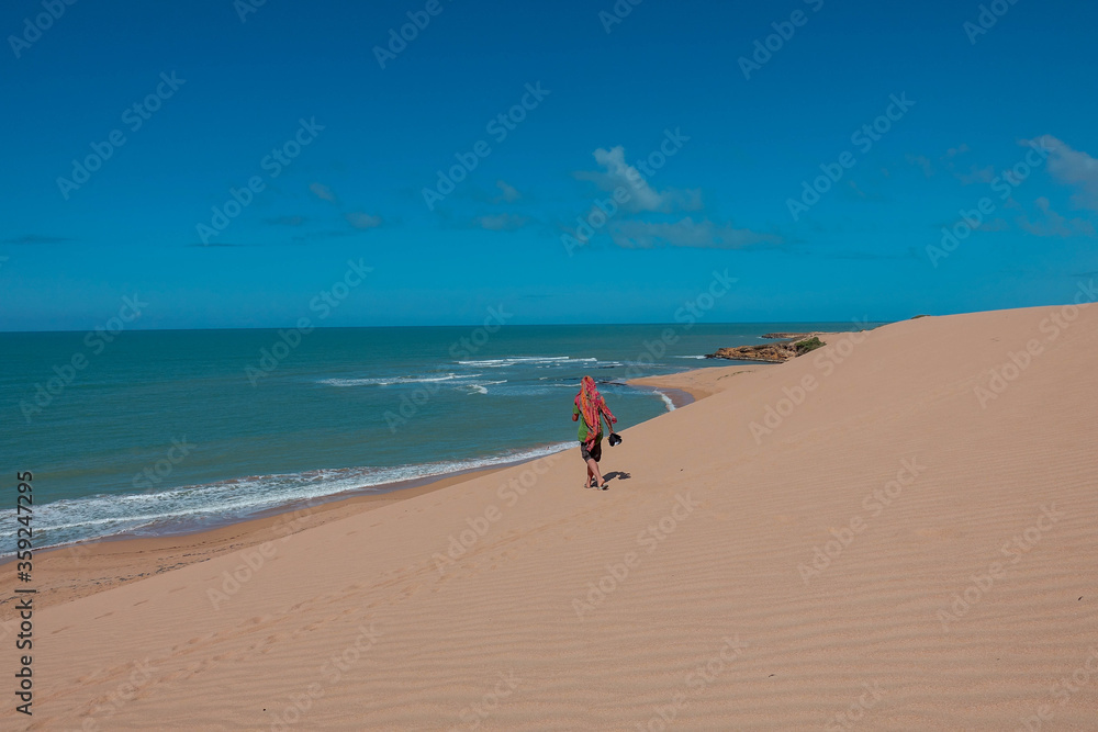 The dunes of Taroa |Man walks over the sand to the beach - Tourism |Punta Gallinas Colombia Travel