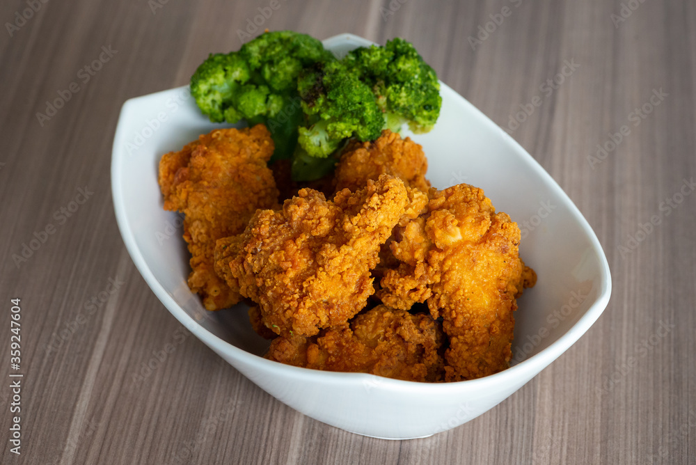 Fried chicken super crispy close up home made bow no brands with broccoli. Tasty and spicy unhealthy food Fried chicken super crispy close up home made bow no brands with broccoli. Tasty and spicy unhealthy food