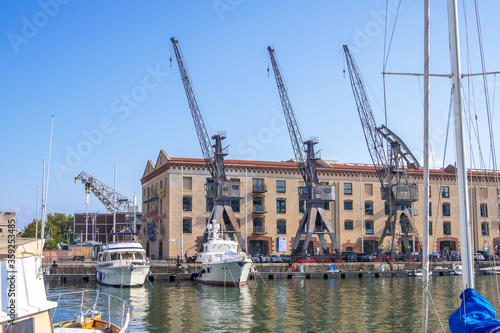 Genoa, Italy - August 18, 2019: Porto Antico di Genova or Old Port of Genoa and the cityscape in the background photo