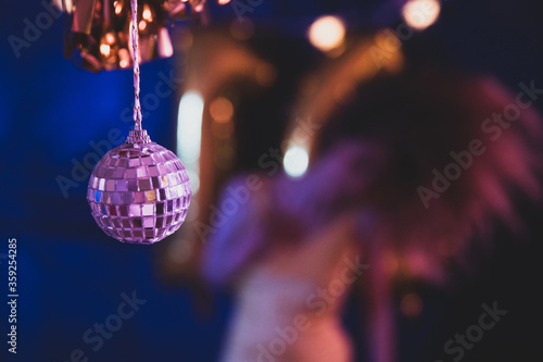 Girl dancing at a party with a disco ball