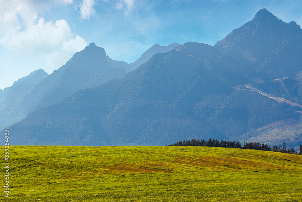 countryside summer landscape. rural fields rolling in to the distant high tatra mountain ridge in slovakia. great scenery on a sunny day