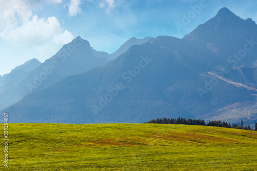 countryside summer landscape. rural fields rolling in to the distant high tatra mountain ridge in slovakia. great scenery on a sunny day