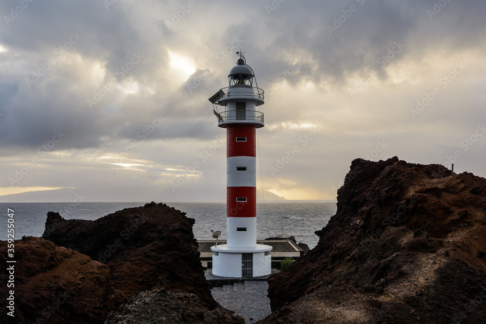 lighthouse in the sunset. lighthouse and thunderclouds.