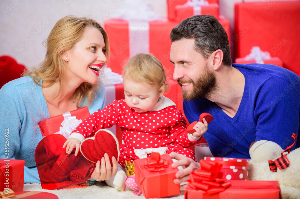 Shopping. Boxing day. Happy family with present box. Love and trust in family. Bearded man and woman with little girl. Valentines day. Red boxes. father, mother and doughter child. I am in love Shopping. Boxing day. Happy family with present box. Love and trust in family. Bearded man and woman with little girl. Valentines day. Red boxes. father, mother and doughter child. I am in love