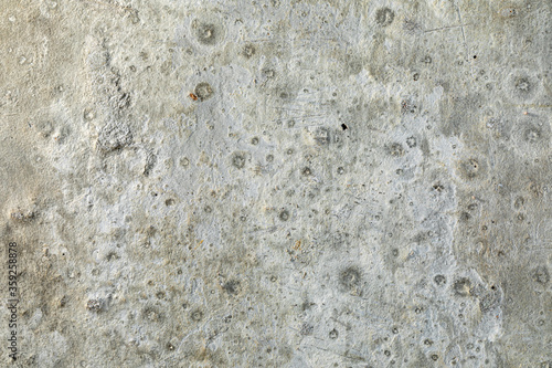 Detailed surface patterns and textures of grey concrete wall close up. Grunge background with copy space.