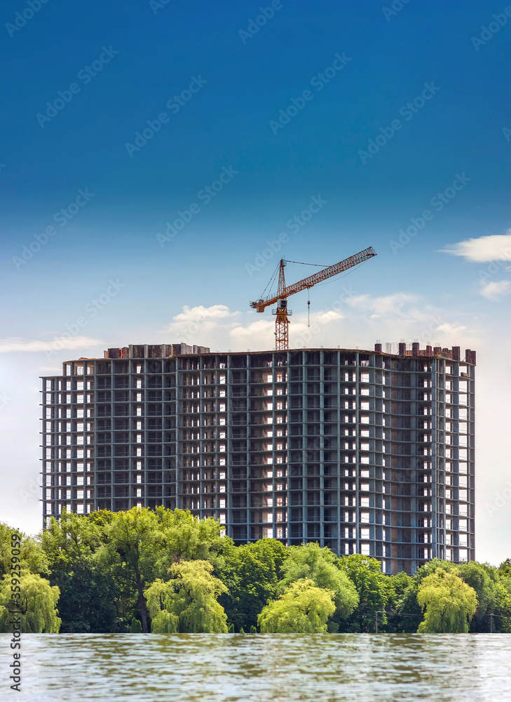 Building under construction on the bank of a big lake. Building under construction on the bank of a big lake.