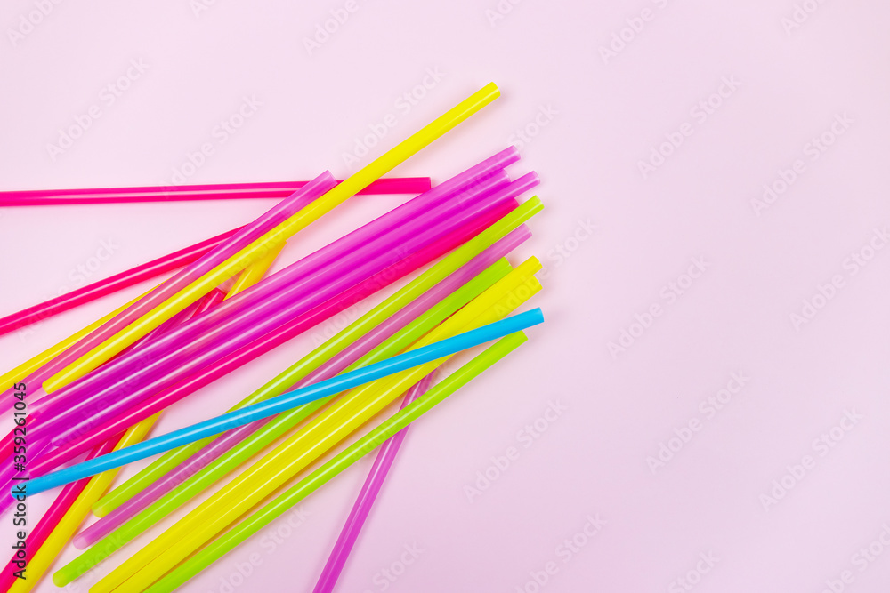 Plastic straws and earth globe, world pollution concept. Single use straws are on the war on plastic. There are plans to ban the sale of plastic straws to help reduce pollution Plastic straws and earth globe, world pollution concept. Single use straws are on the war on plastic. There are plans to ban the sale of plastic straws to help reduce pollution